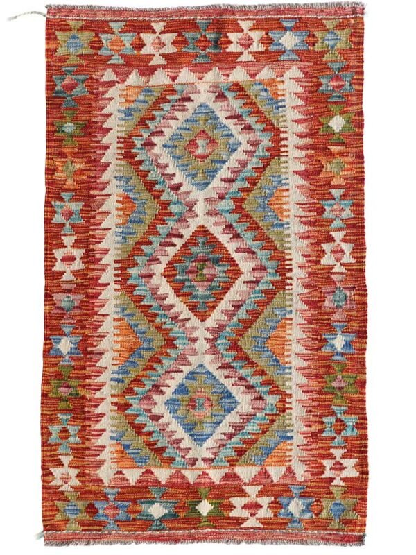 Kilim turco artesanal de 79x129 cm tejido a mano en lana. Diseño tradicional con colores vibrantes. Exclusivo en El Rincón de Fehmi.